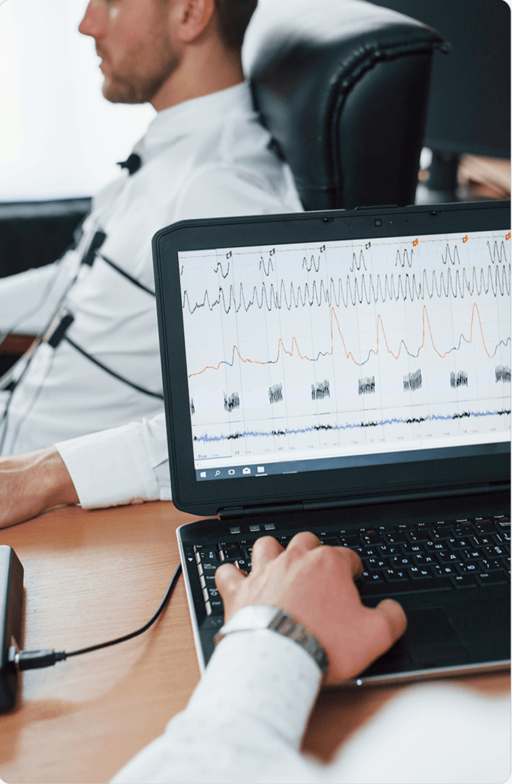 A professional using a tablet dashboard beside connected health and monitoring devices.